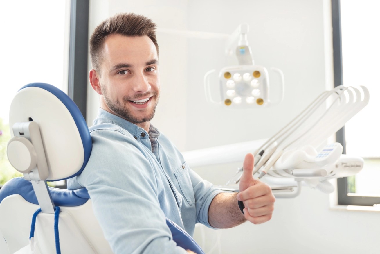 A smiling man showing thumbsup